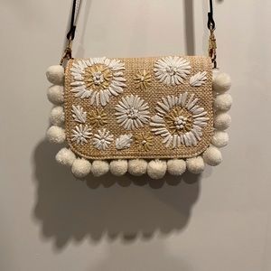 White leather and wicker purse with white poms